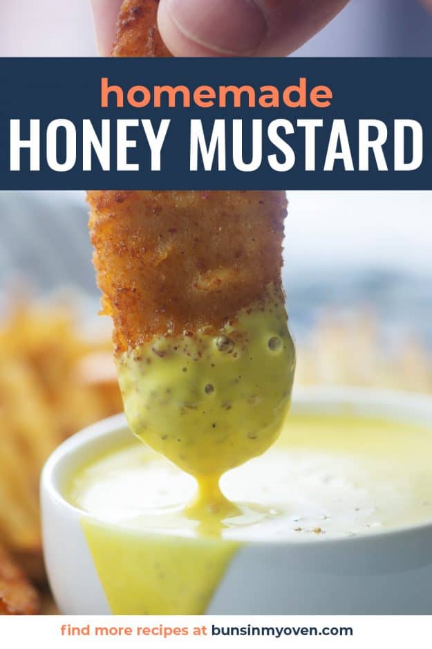 homemade honey mustard dressing in white bowl with a chicken strip