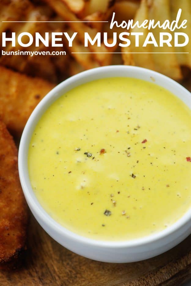 honey mustard recipe in white bowl surrounded by chicken strips and fries