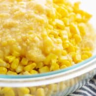 corn casserole ingredients in glass mixing bowl.