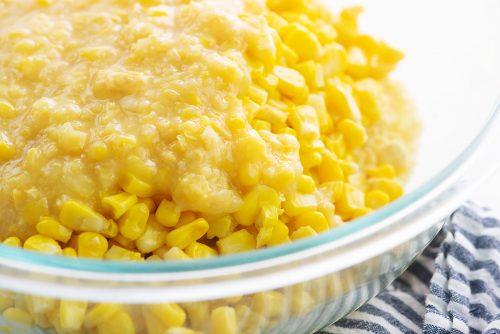 corn casserole ingredients in glass mixing bowl.