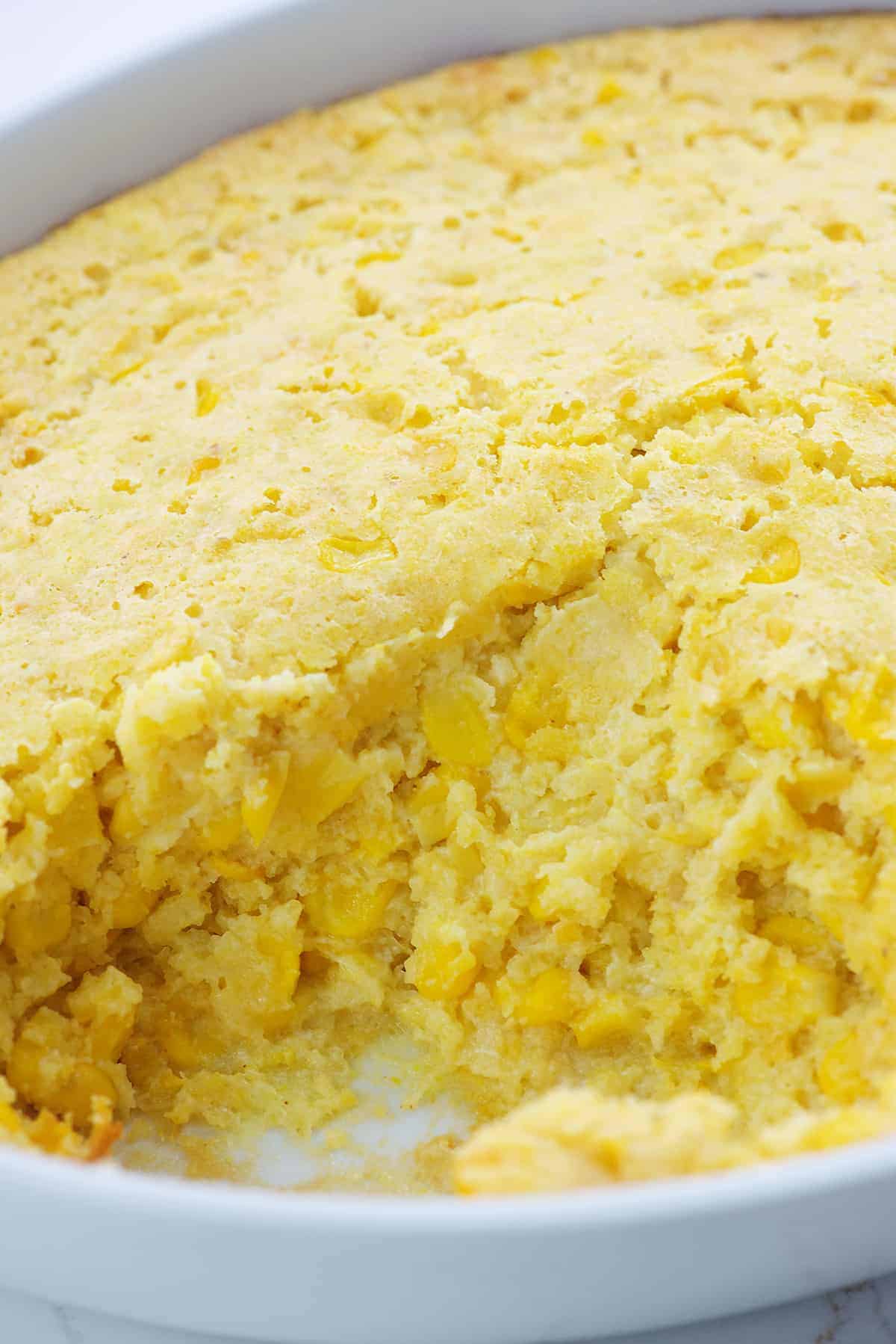 Jiffy corn casserole in white baking dish.