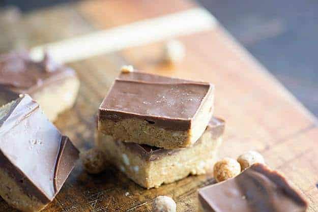 Two stacked up peanut butter bars with chocolate icing.