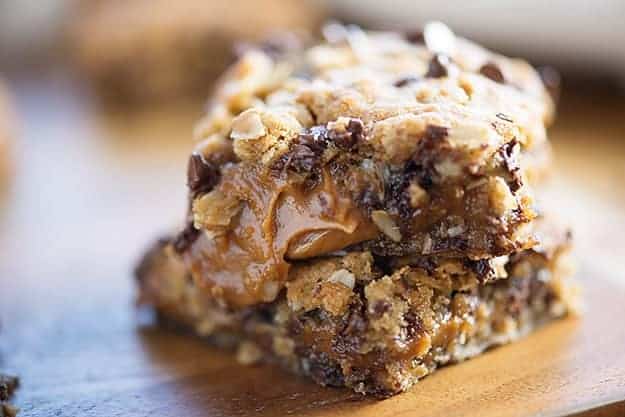 A close up of a couple oatmeal cookie bars stacked up.