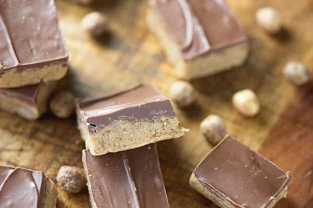 Chocolate peanut butter bars on a wooden cutting board.