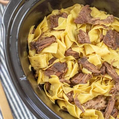 overhead view of beef and noodles in crockpot.