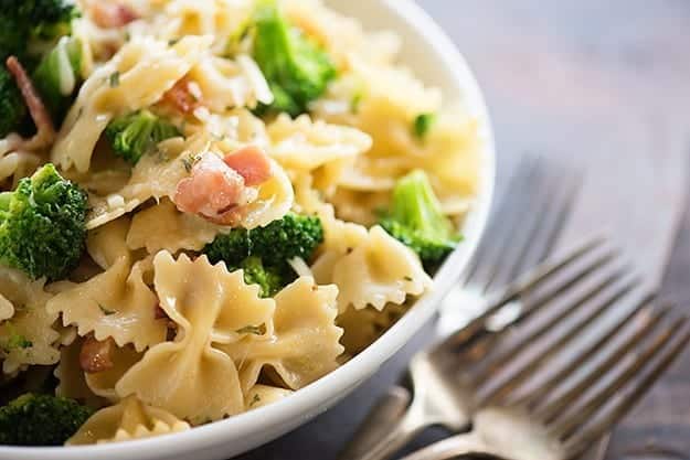 Bowtie pasta with broccoli in a white bowl.