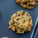 Close up shot of cookie dough spread out on a baking sheet.