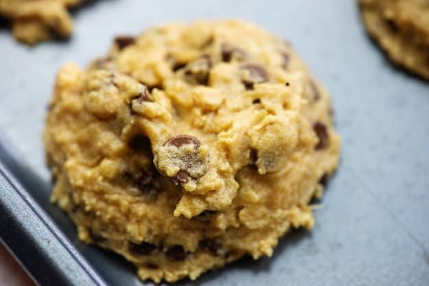 thick and chewy peanut butter cookies with oatmeal and chocolate chips on baking sheet