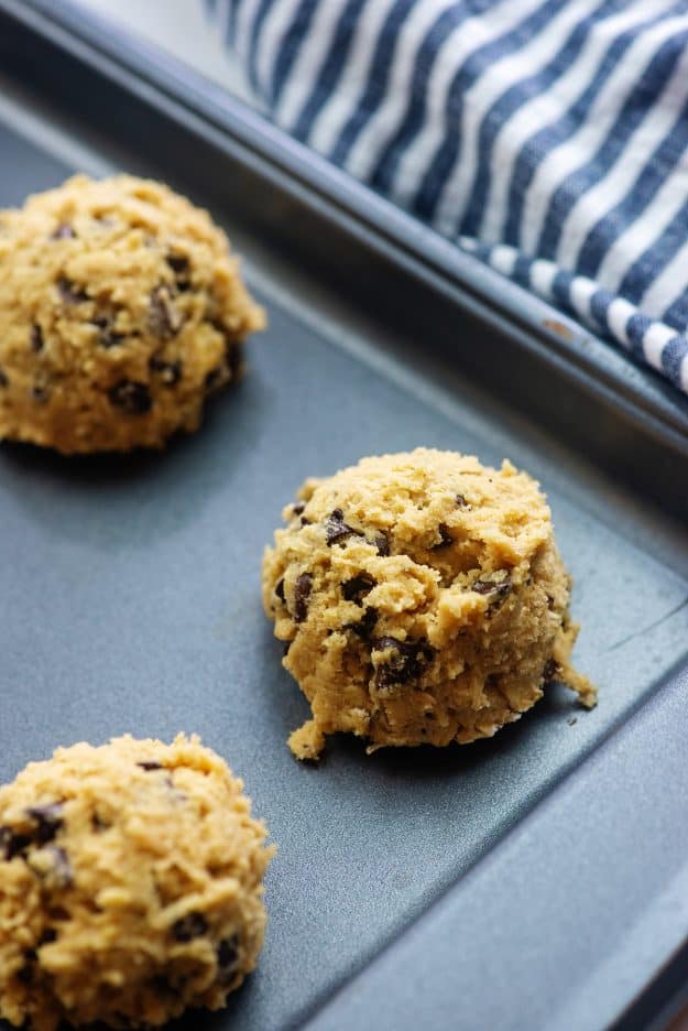 cookie dough on baking sheet with blue striped napkin