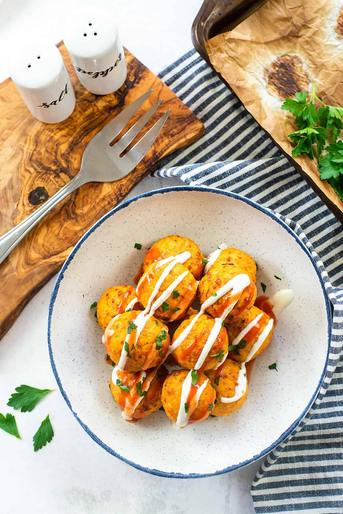 overhead view of buffalo chicken meatballs in bowl.