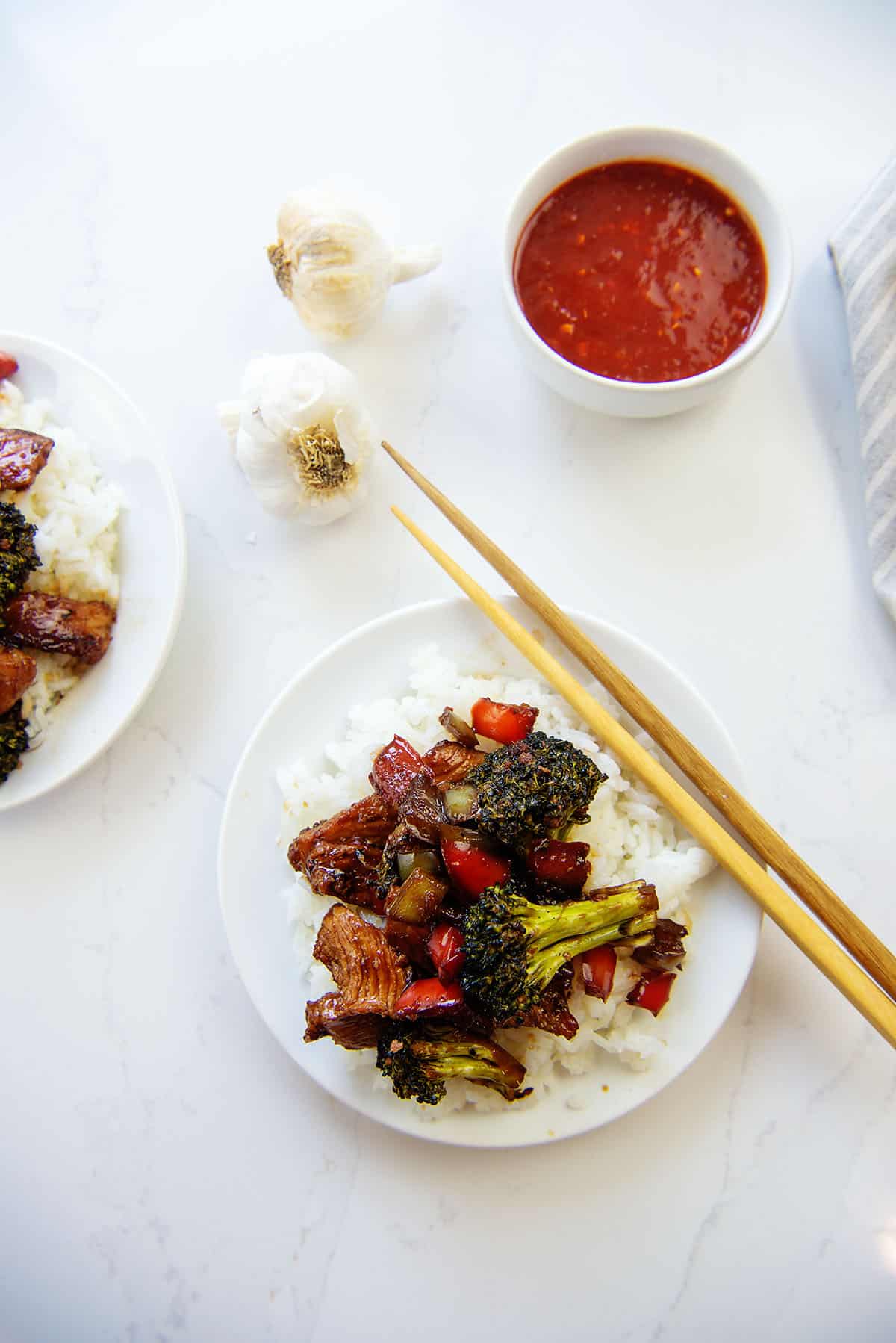 overhead view of pork stir fry on white plate.