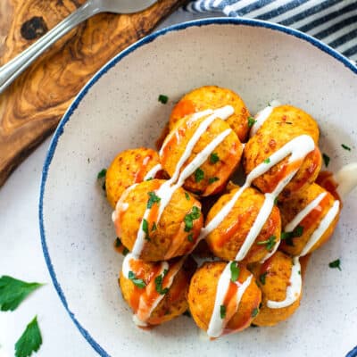 overhead view of buffalo chicken meatballs in white bowl.