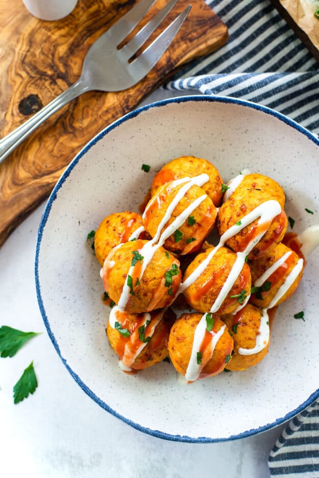 overhead view of buffalo chicken meatballs in white bowl.