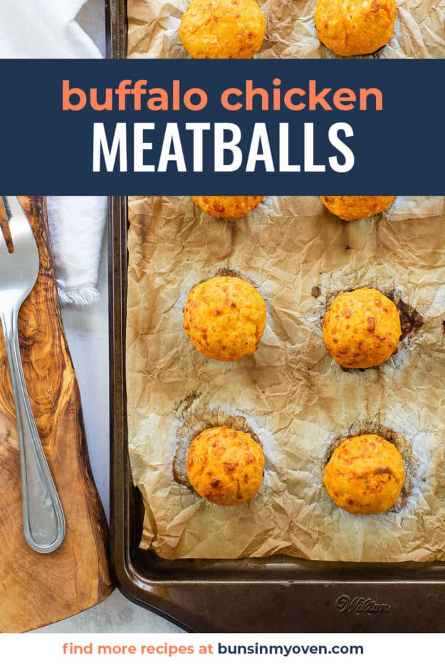 buffalo chicken meatballs on parchment lined baking sheet.