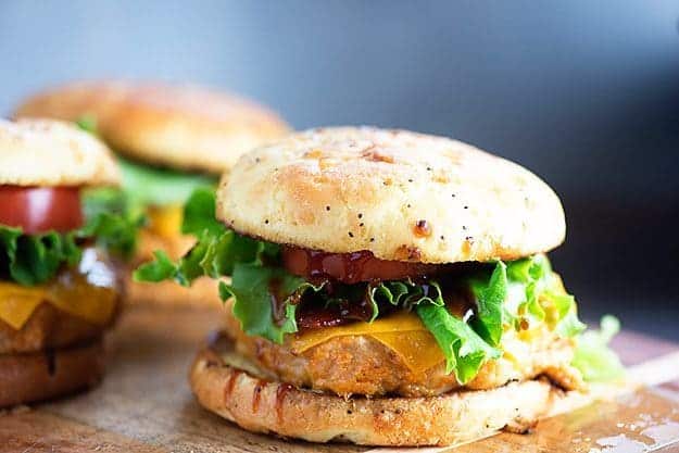 A chicken burger sandwich on a wooden table.