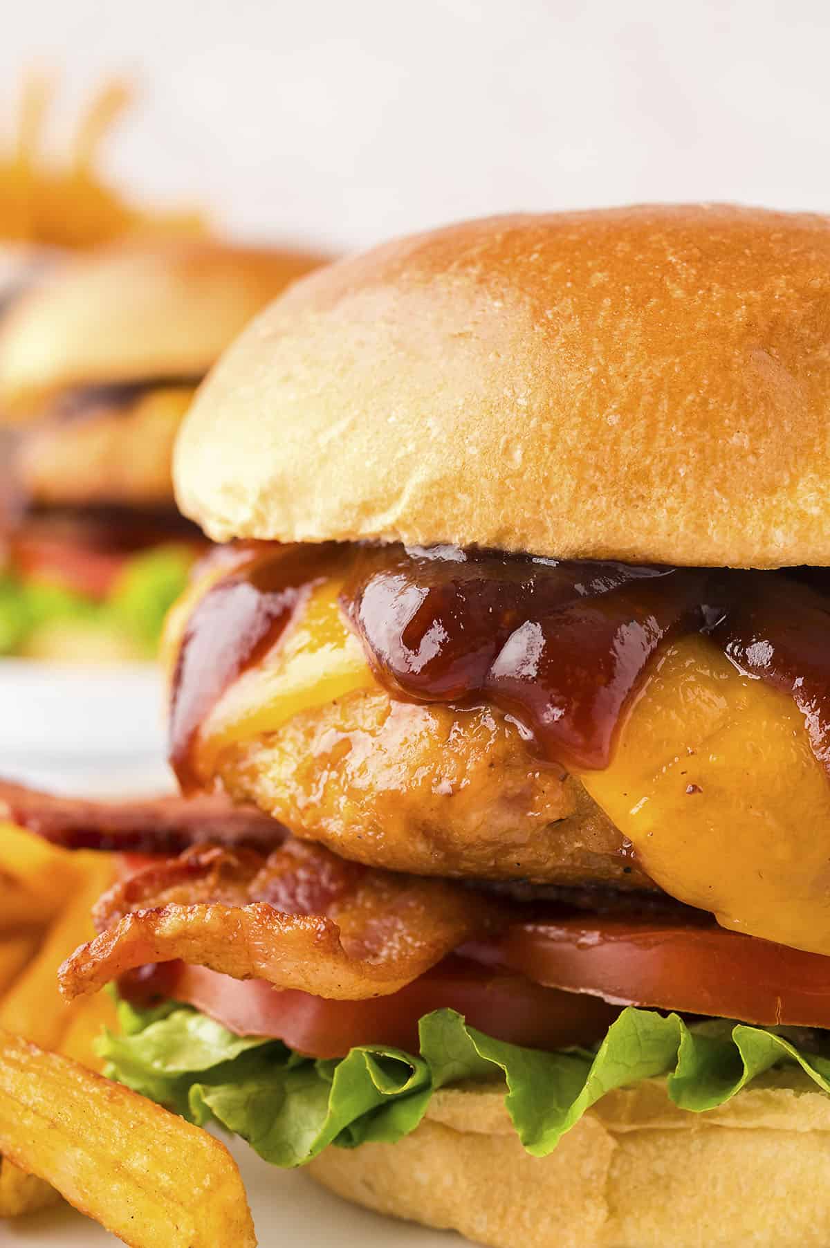 Close up of BBQ chicken burger on bun.