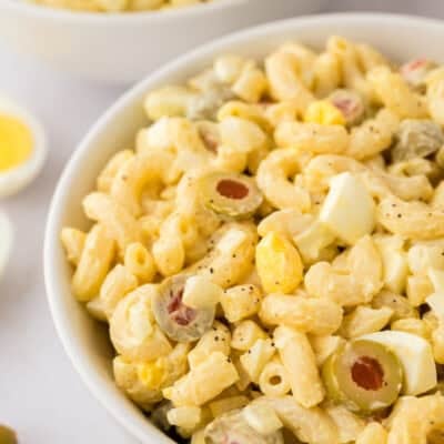 classic macaroni salad in white bowls.