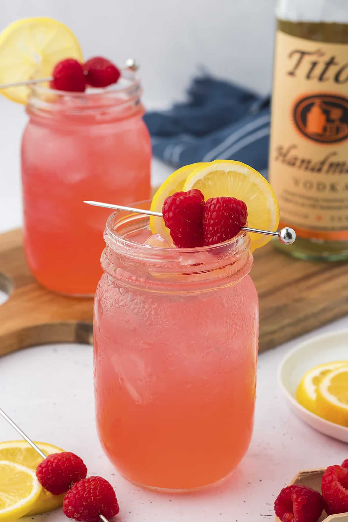 Raspberry vodka collins in mason jar.