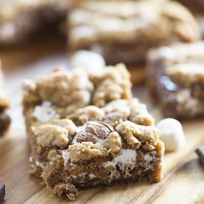 A close up of a smores bar on a wooden cutting board.