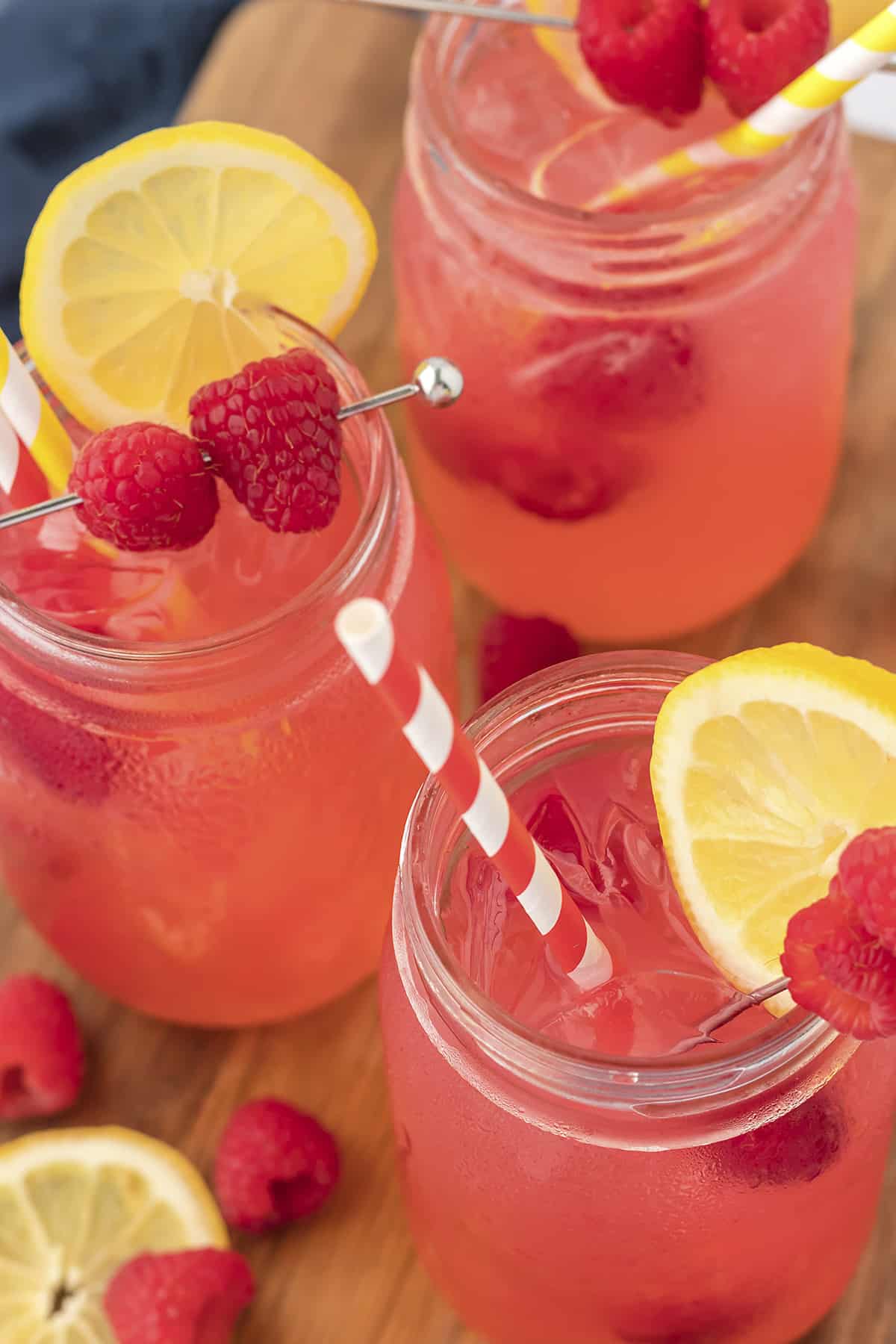 Overhead view of raspberry vodka collins in glasses.