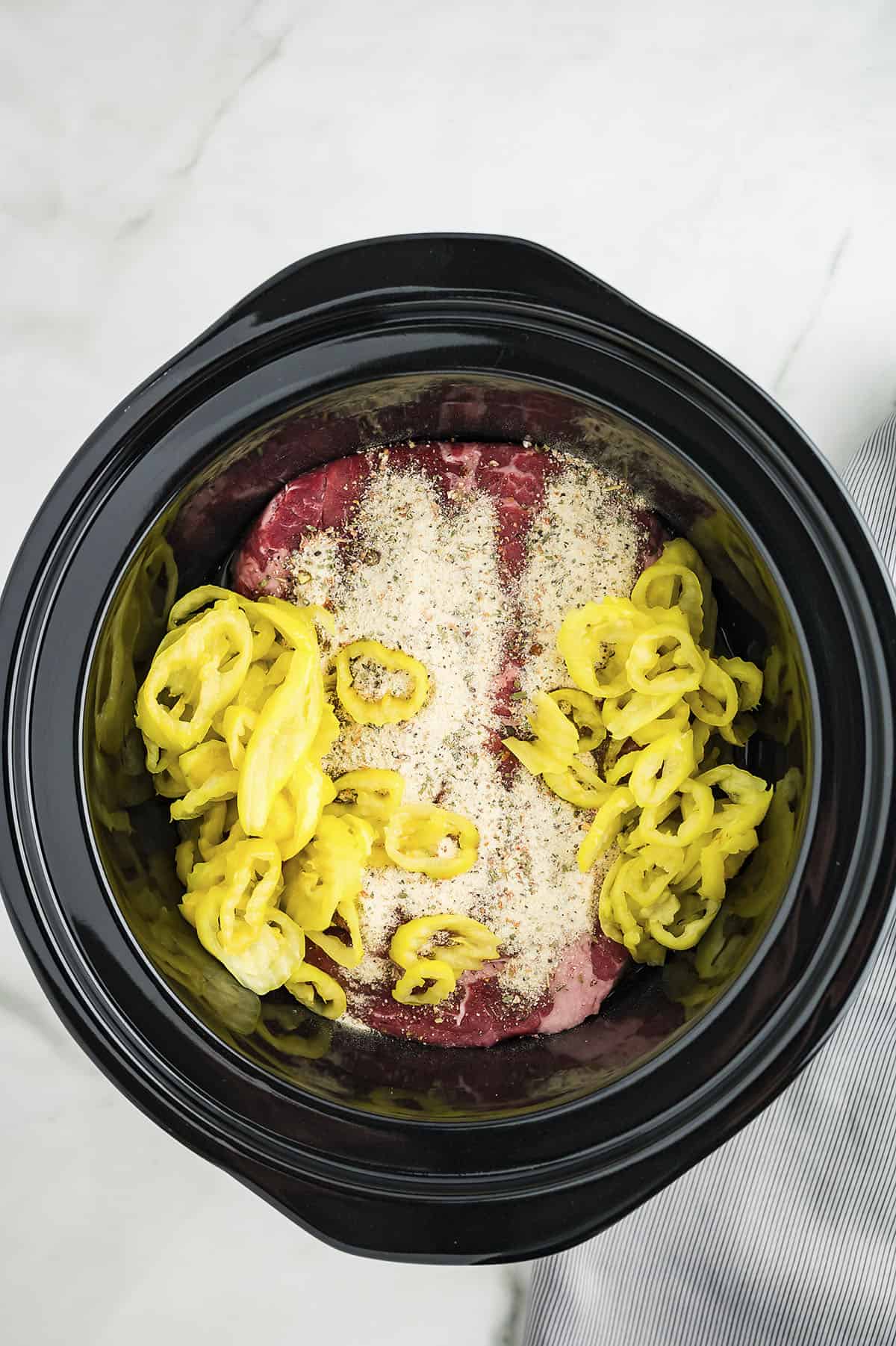 Ingredients for Italian beef sandwiches in crockpot.