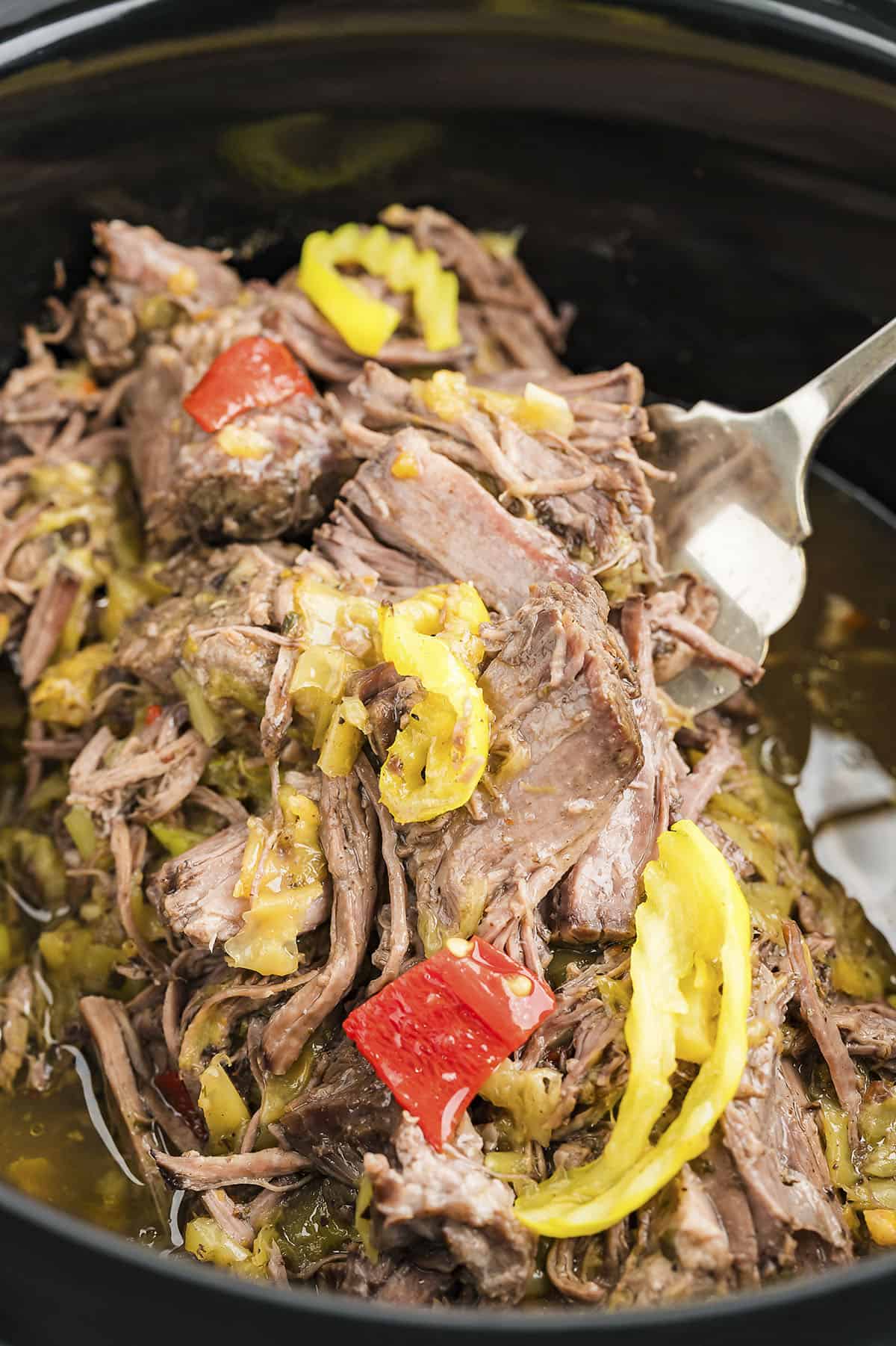 Shredded Italian beef in crockpot.