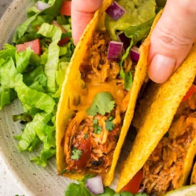 Hand grabbing a crockpot chicken taco.