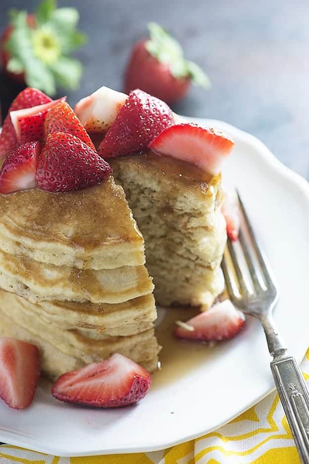 A bite cut out of a stack of pancakes.