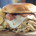 Honey mustard chicken made in the Crock-Pot® slow cooker! The chicken is so flavorful and tender! I love these sandwiches topped with bacon and swiss cheese!