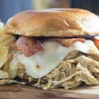 Honey mustard chicken made in the Crock-Pot® slow cooker! The chicken is so flavorful and tender! I love these sandwiches topped with bacon and swiss cheese!