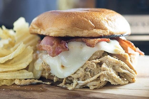 Honey mustard chicken made in the Crock-Pot® slow cooker! The chicken is so flavorful and tender! I love these sandwiches topped with bacon and swiss cheese!