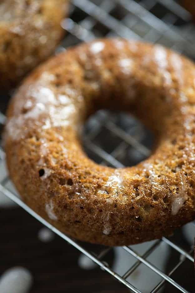 A close up of a doughnut sitting on top of a metal rack