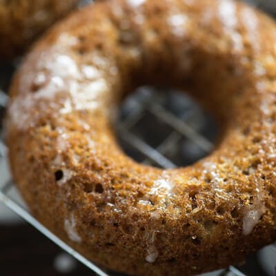 A close up of a doughnut sitting on top of a metal rack