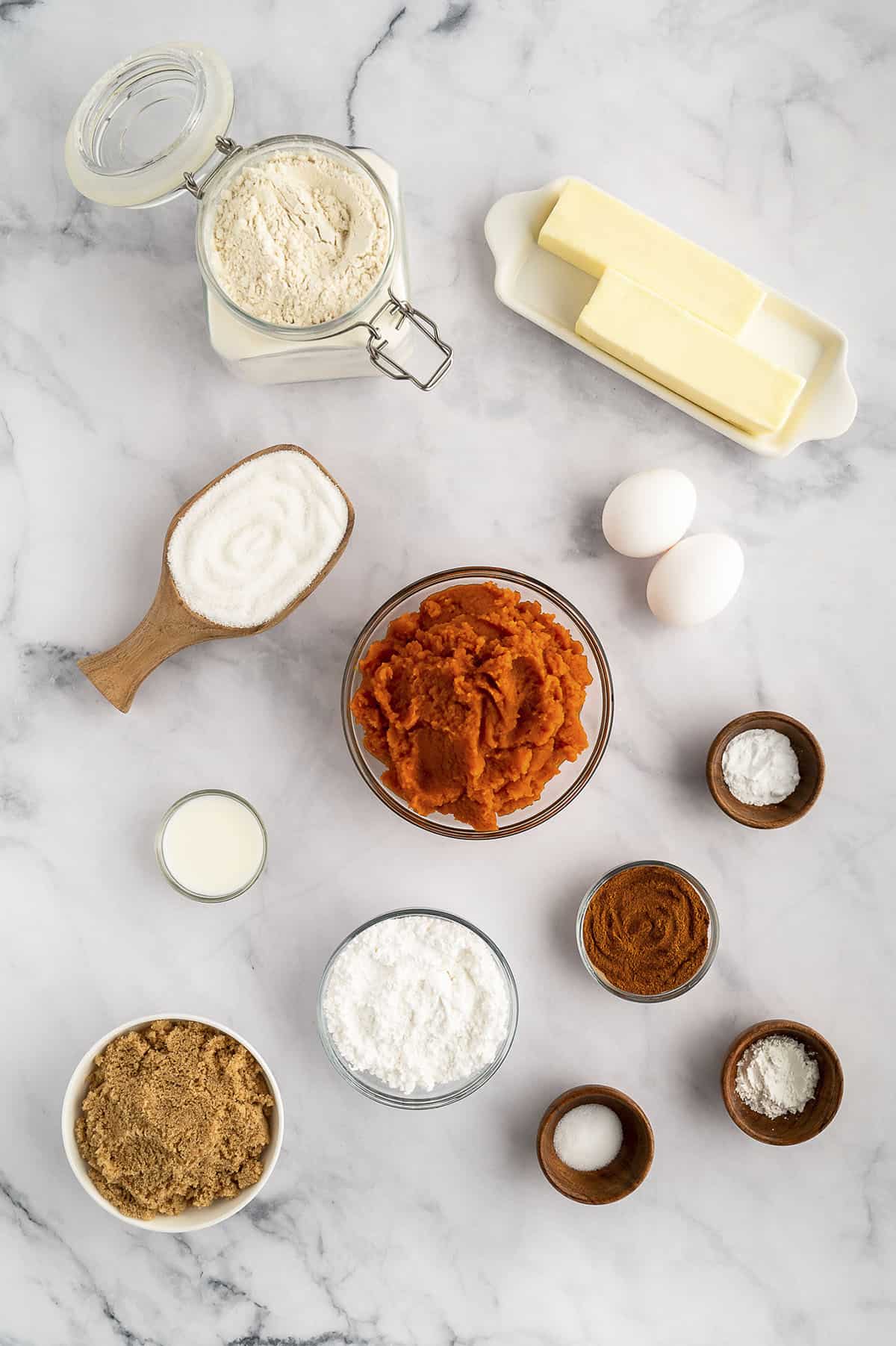 Ingredients for pumpkin coffee cake on marble counter top.