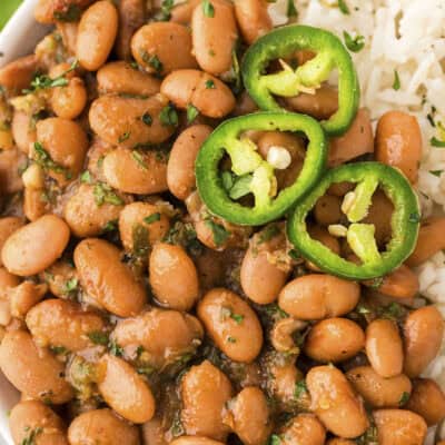 Close up of pinto beans in bowl of rice.