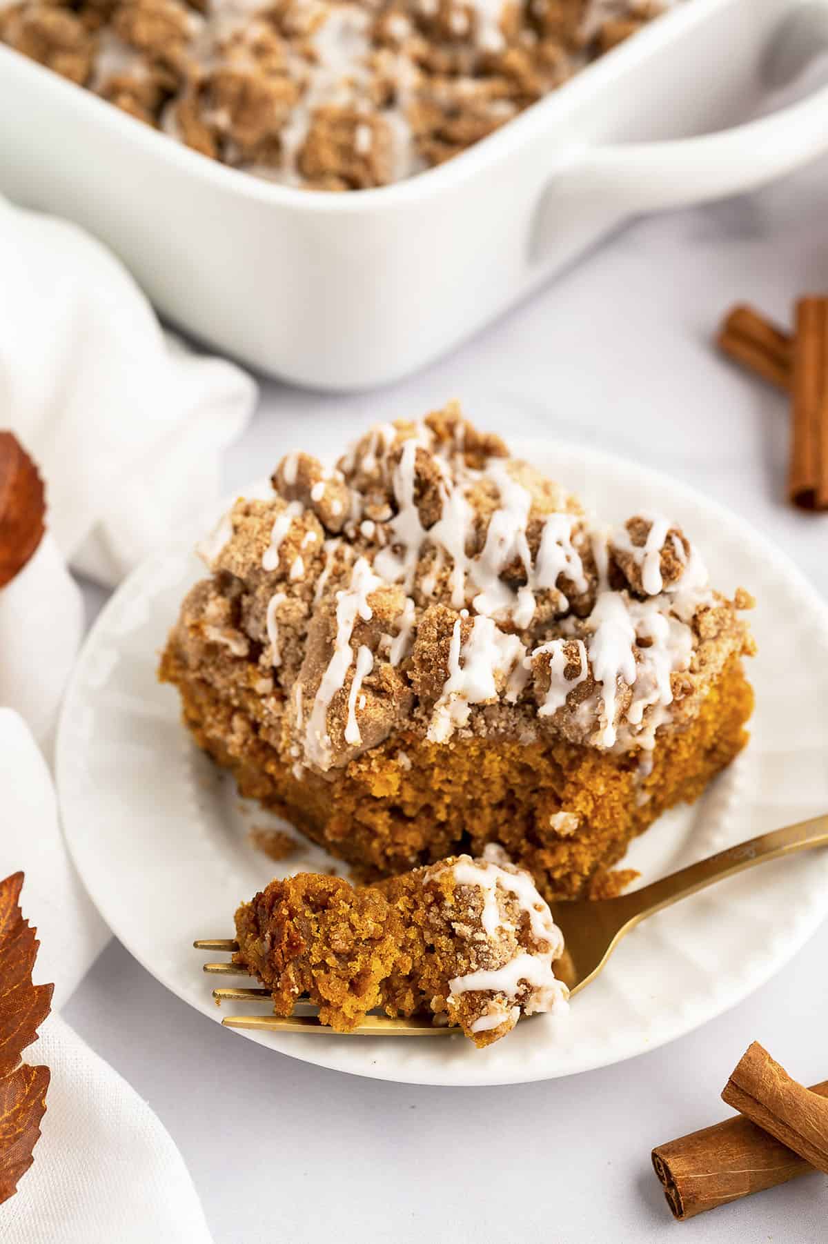 Pumpkin cake recipe on white plate with fork.