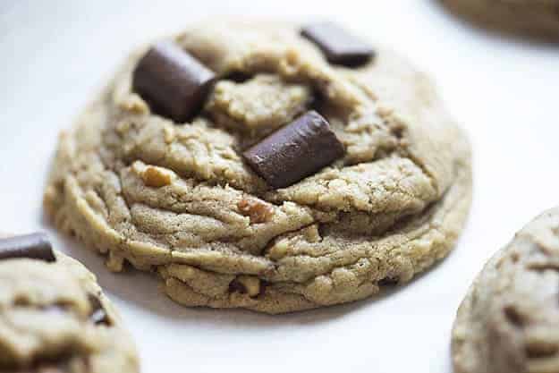 A toffee cookie held up to the camera.