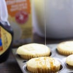 Syrup being drizzled on top of a pancake muffin.
