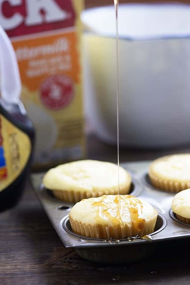 Syrup being drizzled on top of a pancake muffin.