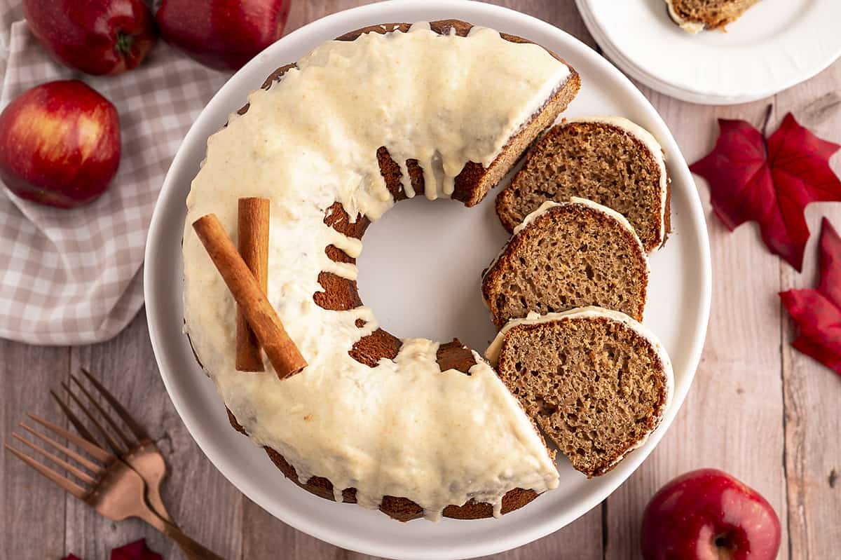 Overhead view of sliced applesauce cake on cake stand.