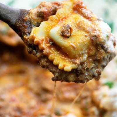 Ravioli on a wooden spoon.