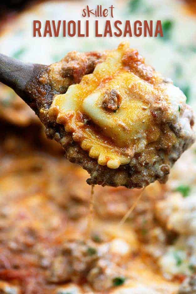 A close up of ravioli on a wooden spoon.