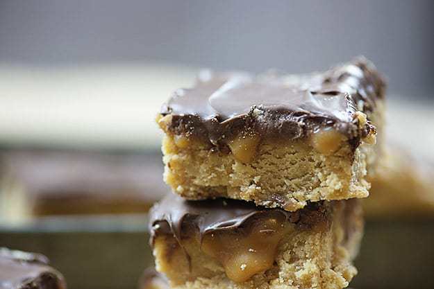 A couple stacked up chocolate peanut butter bars.
