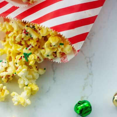 red and white striped bag with popcorn spilling out.