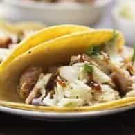 These crunchy pork tacos use pork that's been fried in the oven. They're topped with a simple slaw and barbecue.
