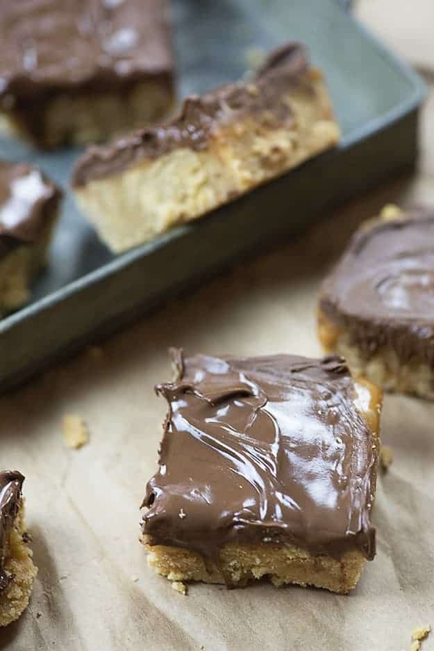 A few chocolate Ritz bar squares in front of a baking sheet.