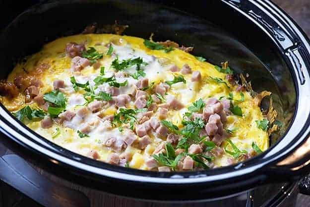This slow cooker breakfast casserole makes a great holiday breakfast or brunch and can really feed a crowd! I love the mixture of cheesy potatoes, ham, and eggs!