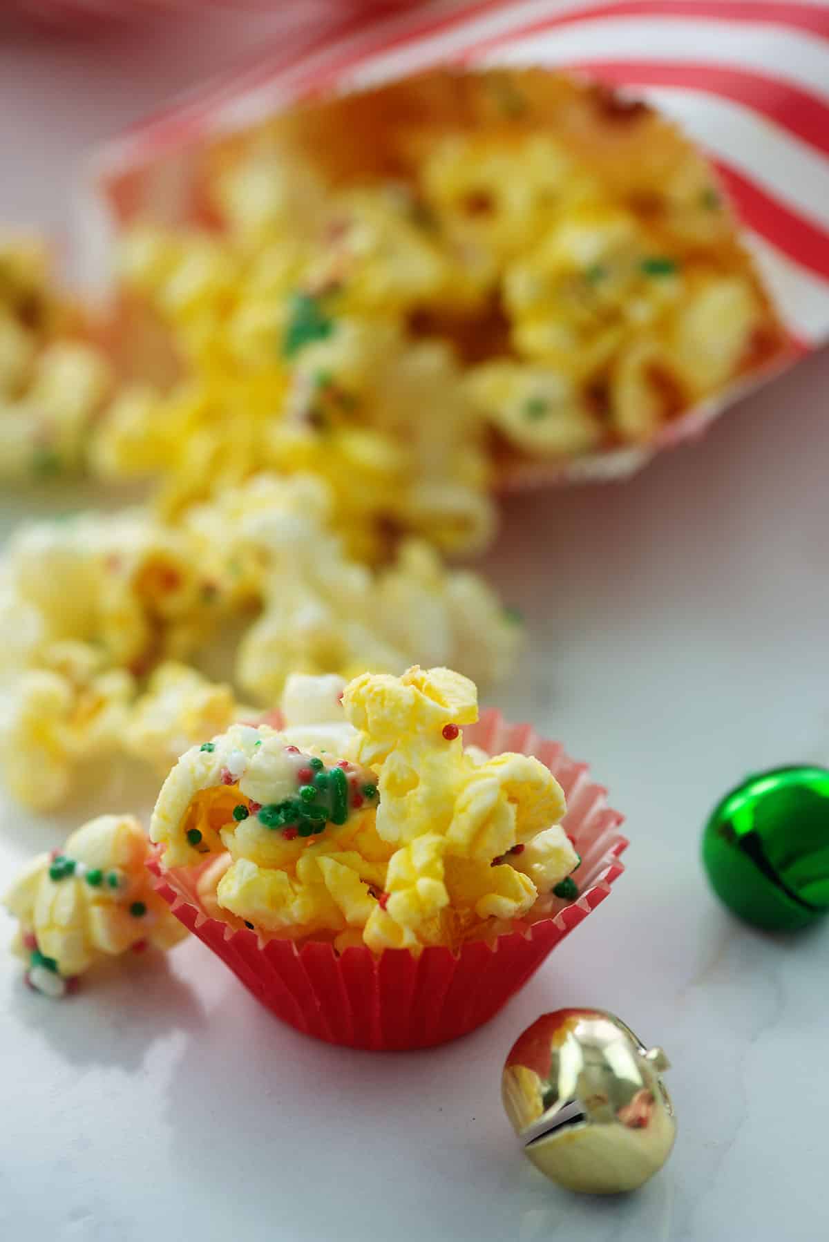 mini cups full of popcorn covered in sprinkles.