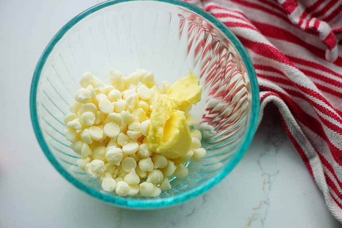 glass bowl full of white chocolate and butter.