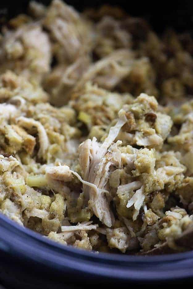 This crock pot chicken and stuffing is total comfort food! The chicken is tender and the stuffing mix cooks right in the slow cooker with the chicken! 
